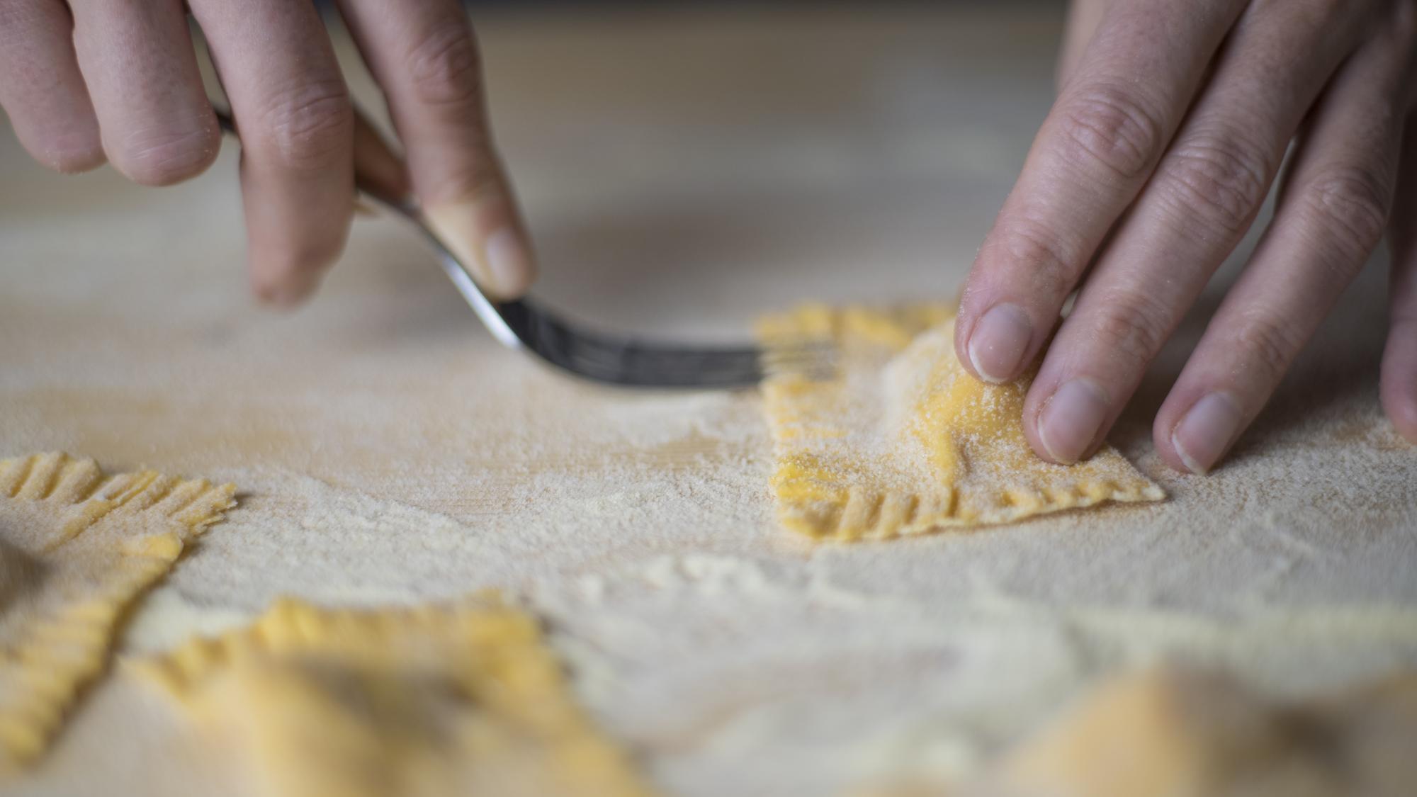 Hands shaping fresh pasta
